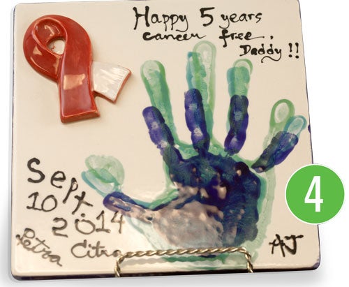 5 year anniversary gift. Ceramic plaque with handprints and red ribbon.